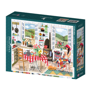The Honeybea 1,000 Piece Jigsaw Puzzle by Pieces & Peace, illustrated by Olivia Gibbs and made in France, shows a cozy kitchen scene with a red-checked tablecloth, cookware, open windows, and a woman at the table.