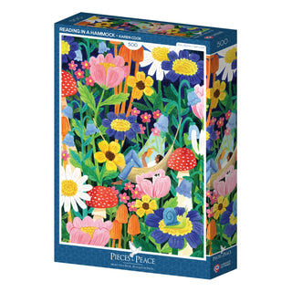 The Pieces & Peace “Reading in a Hammock” 500-piece jigsaw puzzle features a colorful illustration of flowers, plants, and a person reading in a hammock by artist Karen Cook.