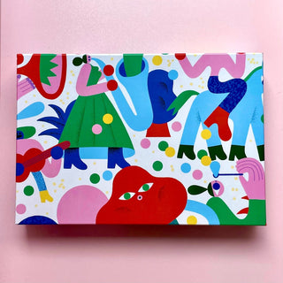 The Dream Parade | 500 Piece Jigsaw Puzzle by Das Puzzle Kollektiv features a vibrant, colorful abstract design with stylized human and animal shapes on a pink background. It's rectangular, plastic-free, and climate-neutral.