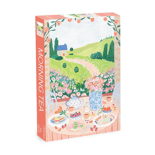 The Morning Tea | 500 Piece Jigsaw Puzzle by Olleo Puzzles features an illustrated outdoor tea table scene with food, flowers, and a countryside view. Includes a convenient cotton storage bag.