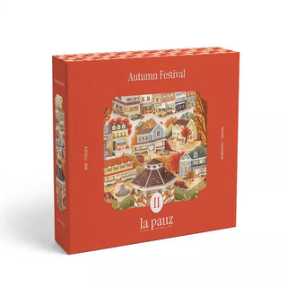 Sure! Here’s a rewritten version using your product data: The Autumn Festival | 500 Piece Jigsaw Puzzle by la pauz features a beautifully illustrated fall village scene in warm hues on the box, perfect for cozy nights at home. Ideal for fans of seasonal themes or anyone seeking that charming Gilmore Girls puzzle atmosphere, this Autumn Festival puzzle is sure to delight.