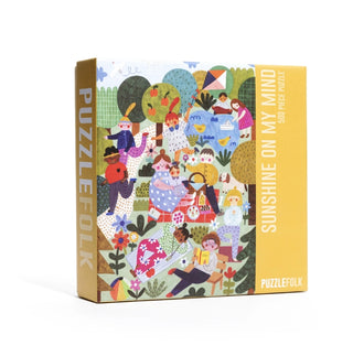 The Sunshine On My Mind | 500 Piece Jigsaw Puzzle by Puzzlefolk features a vibrant park picnic scene, offering a delightful puzzle challenge for the whole family to enjoy together.