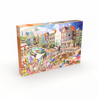 The Penny Puzzle "Home of Canals" 1,000 piece jigsaw puzzle features a rectangular box with an illustrated cityscape of canal houses, bicycles, vibrant buildings, and people enjoying outdoor activities.