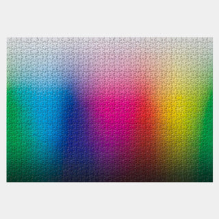 The Play Group’s “1000 Smaller Colours” 1,000 piece jigsaw puzzle features a smooth gradient with vertical bands of blue, green, pink, yellow, and black that shift from light at the top to dark at the bottom.