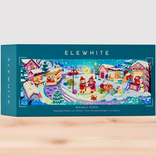 ELEWHITE’s Whimsy Town | 1,000 Piece Jigsaw Puzzle features a vibrant winter town scene with houses, snowmen, and two Santas. This panoramic puzzle showcases original artwork printed on a premium puzzle board. The box displays the text: “WHIMSY TOWN Panoramic Puzzle 1000 Pieces.”.