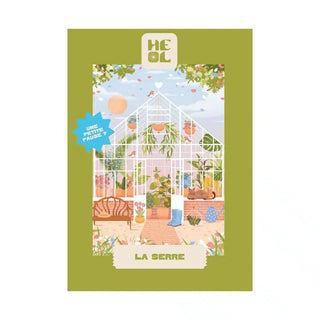 Illustration of a greenhouse with plants, wooden furniture, and a watering can; text reads “La Serre” and “Heol Editions” with a blue star saying “UNE PETITE PAUSE?”—a charming 99 piece jigsaw puzzle made in France.