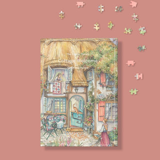 The Puzzle Theory’s “Cottage Welcome” is an 896-piece eco-friendly jigsaw puzzle featuring a cozy cottage scene on a pink background, with scattered pieces inviting you to complete this charming artwork.