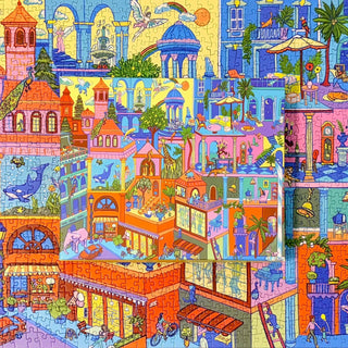 Wild Thing by Mango Puzzles is a 1,000 piece jigsaw featuring vibrant buildings and lively city scenes, with a smaller finished puzzle matching the background for a whimsical touch.