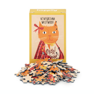 A yellow mini puzzle box from Happily Jigsaw Puzzles features the 99-piece Vivfuriene Westwood jigsaw, showing an orange cat in a plaid jacket and bow, with loose pieces visible in front. Box made from recycled board.
