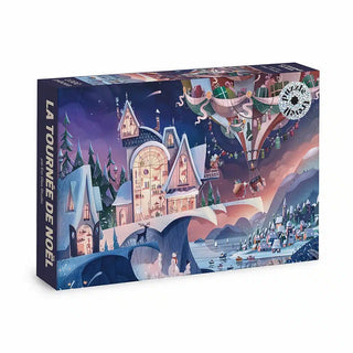 La Tournée de Noël | 1,000 Piece Jigsaw Puzzle by Trevell features a festive winter scene with a snowy village, Christmas house, and hot air balloon.