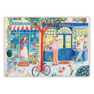 Illustrated street scene with a flower shop, bookstore, people, red bicycle, plants, dog, rooster & tree—Rue Des Jolies Choses by Aparté is a charming 500 piece jigsaw puzzle.