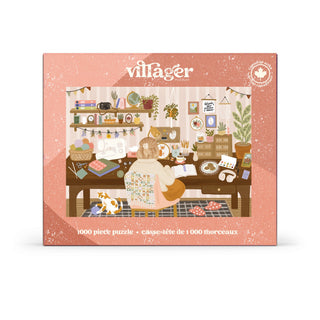Villager Puzzles’ Grandma Hobbies | 1,000 Piece Jigsaw Puzzle features an illustration of a cozy home office with a person reading at a desk, surrounded by plants, books, and cats. Designed in Canada, this charming puzzle is perfect for fans of cozy puzzles and Grandma Hobbies. The box displays the Villager Puzzles logo and “1,000 Piece Puzzle” in both English and French.