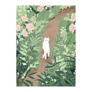 A white cat with a collar strolls alone along Trevell’s lush Pathway, surrounded by greenery and pink blooms—just like the whimsical scene in the Trevell Pathway | 99 Piece Jigsaw Puzzle.