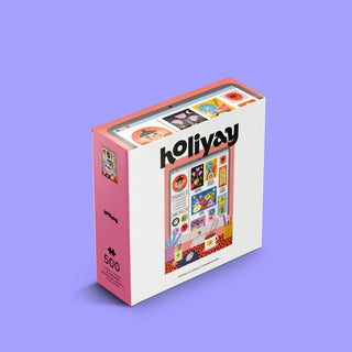 A rectangular box labeled Holiyay Puzzles contains the Colorful Portfolio 500 Piece Jigsaw Puzzle, featuring whimsical illustrations by Teresa Bellón on the cover, set against a light purple background.