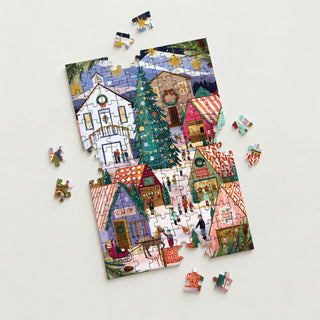 A partially assembled Christmas Market | 150 Piece Jigsaw Puzzle by Spaghetti Tree featuring a snowy scene with a central pine tree, vendor stalls, and people.