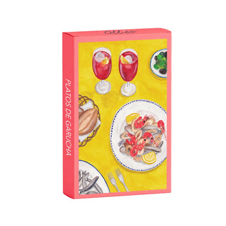 A vibrant box labeled "Platos De Garucha | 99 Piece Jigsaw Puzzle" by Olleo Puzzles features illustrated seafood, red drinks with ice, olives, and cutlery on a yellow background in a Spanish-style table design.
