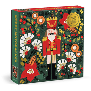 The Merry Nutcracker 500 Piece Jigsaw Puzzle by Galison features a festive nutcracker in a red uniform amid holiday flowers and greenery—a charming seasonal puzzle perfect for holiday enjoyment.