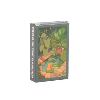 Trevell’s Frog in the Garden | 99 Piece Jigsaw Puzzle showcases a charming frog by a pond, surrounded by plants and stones—a delightful mini puzzle ideal for nature lovers.