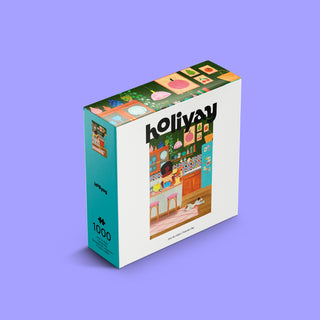A 1,000-piece jigsaw puzzle box labeled "Pancake Day" by Holiyay Puzzles stands upright on a purple background, featuring an illustrated kitchen scene on the front. This puzzle boasts a premium matte finish that adds an elegant touch and reduces glare while puzzling.
