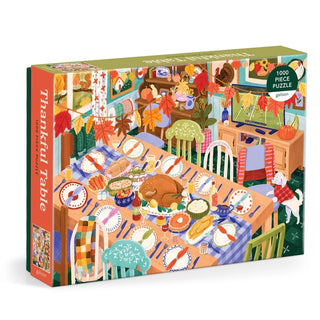 The "Thankful Table" 1,000 Piece Jigsaw Puzzle by Galison showcases an illustrated Thanksgiving scene with a golden roast turkey, lavish holiday dishes, festive autumn décor, and a cheerful dog in a vibrant dining room.