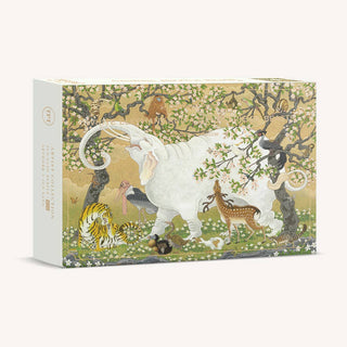 Experience the captivating world of “White Elephant and A Menagerie of Beast,” a 1,000 piece jigsaw puzzle by The Puzzle Theory. Illustrated by Jun Sato Art, this pearlescent puzzle features a majestic white elephant amidst trees and flowers, surrounded by a vibrant tiger, graceful deer, colorful birds, and playful monkeys—all beautifully displayed on the puzzle box.