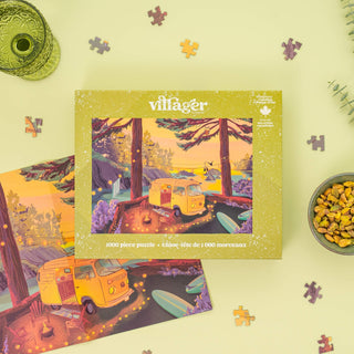 The Twilight Campsite 1,000 piece jigsaw puzzle by Villager Puzzles features a vibrant camper van lakeside scene, perfect for fans of camping posters or coastal decor.