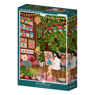 A 1,000-piece jigsaw puzzle by Pieces & Peace, titled "Cozy Cottage," features artwork by Nidhi Kachhadiya depicting a woman painting flowers in a warm, plant-filled cottage surrounded by colorful art supplies and flower-themed decorations. Made in France.