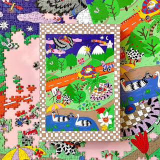 A finished 5 Seconds Later | 1,000 Piece Jigsaw Puzzle showing a whimsical landscape with a flying pigeon, a snail on a road, a picnic, two swans in a pond, and loose puzzle pieces.
