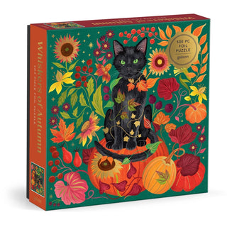 The Whiskers of Autumn | 500 Piece Jigsaw Puzzle by Galison comes in a beautifully designed box featuring a black cat nestled among vibrant autumn leaves, berries, sunflowers, and harvest pumpkins. With its green and orange hues highlighted by gold foil accents, this folk art-inspired puzzle makes a delightful addition to any black cat puzzle collection.