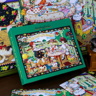 A WEVE "A Friend Is A Gift" 1,000 piece jigsaw puzzle box, featuring an illustration of children having an outdoor tea party, is shown alongside the completed puzzle and loose pieces—all crafted from recycled paper.
