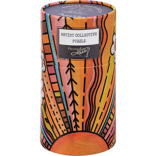 Cylindrical box with colorful abstract floral sunburst art, labeled Primitives by Kathy. The Floral Sun 500 Piece Jigsaw Puzzle is a vibrant gift perfect for art lovers.