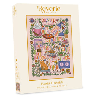 The Puzzler Essentials | 1,000 Piece Jigsaw Puzzle by Reverie Puzzles showcases vibrant artwork by Stephanie Kate Illustration featuring colorful puzzle accessories and related items on the front of the box.