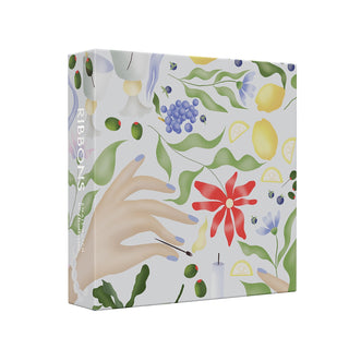 The Ribbons | 1,000 Piece Jigsaw Puzzle by Cloudberries is a square box with a floral and fruit pattern, featuring hands and garden illustrations. Designed by Victoire Douy, “RIBBONS” is printed on the spine of this charming puzzle.