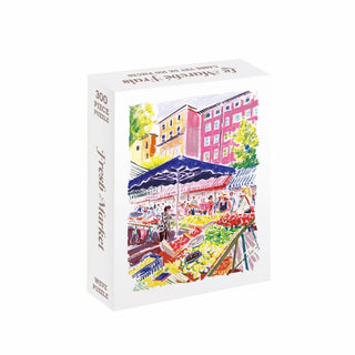 Discover the Fresh Market | 300 Piece Jigsaw Puzzle by WEVE, a vibrant puzzle made from recycled paper. Featuring a lively scene of an outdoor market with fruit stands, colorful umbrellas, and charming buildings in the background, this eco-friendly puzzle offers hours of engaging and sustainable fun as you piece together each cheerful detail.
