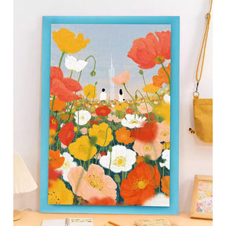 The "Poppy Spring | 1,000 Piece Jigsaw Puzzle" by Momibook features a framed illustration of colorful poppy flowers, blue border, and two small white ghosts—ideal for puzzle enthusiasts seeking a vibrant, whimsical challenge.