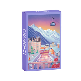 The Chamonix | 99 Piece Jigsaw Puzzle by Olleo Puzzles features Cindy Tardiou's winter scene with mountains, buildings, gondola, and skating rink at sunset—beautiful to display once completed.