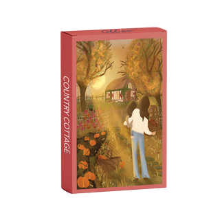 The Olleo Puzzles Country Cottage is a 99-piece jigsaw puzzle featuring two people walking toward a cottage amid autumn trees, pumpkins, and a garden.