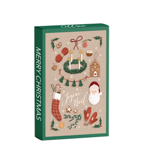The Merry Christmas | 99 Piece Jigsaw Puzzle by Olleo Puzzles comes in a green rectangular box with festive art by Charlène Girodet—Santa, wreath with candles, stocking, mittens, holly, gingerbread house, and “Joyeux Noël.”.