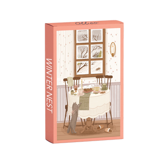 Winter Nest | 99 Piece Jigsaw Puzzle by Olleo Puzzles features Charlène Girodet’s art of a cozy dining table by a snowy window, with chairs, food, a gray cat, and slippers—capturing a heartwarming winter scene.