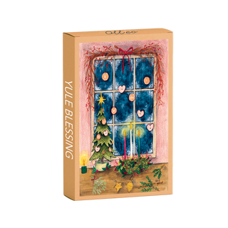 Yule Blessing | 99 Piece Jigsaw Puzzle by Olleo Puzzles comes in a decorated box featuring Louise Gobinet’s artwork of a festive window scene with ornaments, a small tree, and holiday décor.