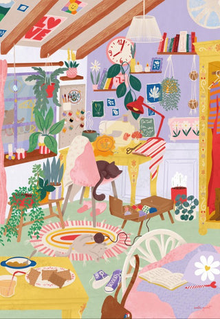 Bright and lively, this Creative Crafts Corner | 1,000 Piece Jigsaw Puzzle from Pieces & Peace captures a colorful, bustling room full of plants, a desk with chair, books, wall art, and an array of personal treasures—including a curious cat on the floor and snacks atop a small table. Designed by Emilie Gauvrit and made in France.