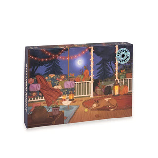 Experience the warmth and charm of Trevell’s Autumn Night | 1,000 Piece Jigsaw Puzzle by Giulia Varetto. This puzzle showcases a cozy nighttime porch scene with pumpkins, soft blankets, a sleeping dog, and glowing string lights beneath a crescent moon.
