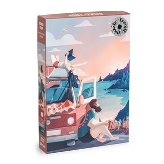 Introducing the [Limited Edition] Road Trip 500 Piece Jigsaw Puzzle by Trevell—a unique puzzle featuring an illustrated scene of two people relaxing by a van near a lake and mountains at sunset, exclusively from Eor Glas Studio.