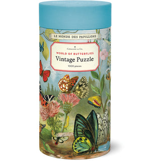 The World of Butterflies | 1,000 Piece Jigsaw Puzzle by Cavallini & Co. comes in a cylindrical box featuring vintage-style colorful butterfly illustrations on the packaging.