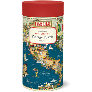A cylindrical container with a red lid labeled Cavallini & Co. Buon Appetito | 1,000 Piece Jigsaw Puzzle, featuring an illustrated map of Italy adorned with famous landmarks and food motifs.