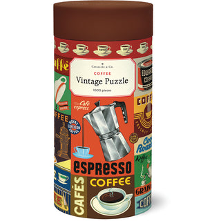 A cylindrical Cavallini & Co. container holds the "Coffee | 1,000 Piece Jigsaw Puzzle," featuring vibrant vintage coffee-themed illustrations.