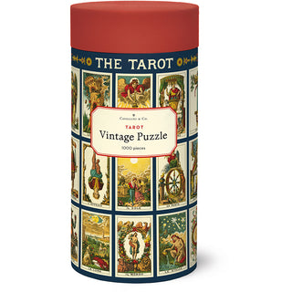 A cylindrical Tarot | 1,000 Piece Jigsaw Puzzle tin by Cavallini & Co. decorated with a grid of vintage tarot card illustrations.