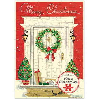 Introducing the “Christmas Home | 60 Piece Greeting Card Jigsaw Puzzle” from Cavallini & Co. This charming holiday greeting card features a beautifully illustrated front door decorated with a festive wreath, two glowing lanterns, Christmas trees, wrapped gifts, and a joyful ‘Merry Christmas’ message. With a 60-piece jigsaw puzzle included and highlighted on the front, this delightful keepsake is the perfect way to send festive cheer all season long.