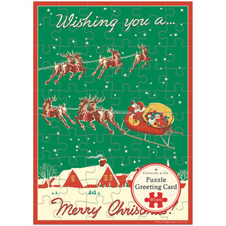 Send warm wishes this season with the Cavallini & Co. Christmas Reindeer | 60 Piece Greeting Card Jigsaw Puzzle, featuring Santa in a sleigh pulled by reindeer over a snowy village and the cheerful message “Wishing you a Merry Christmas!”.
