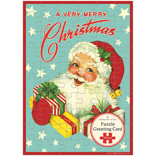The Cavallini & Co. Christmas Santa | 60 Piece Greeting Card Jigsaw Puzzle showcases a vintage illustration of Santa Claus with gifts, accompanied by the nostalgic text “A Very Merry Christmas.”.